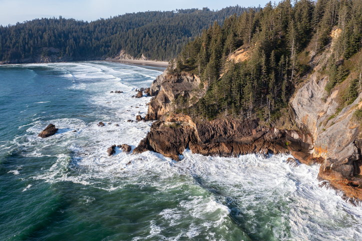 High quality aerial drone photo of Devil's Cauldron at Elk Flats Trail in the beautiful Oregon Coast, near Manzanita, rocky beaches, and great views towards the Pacific Ocean.