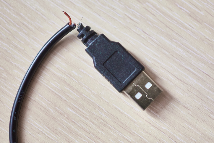 Broken usb cable on a wooden table